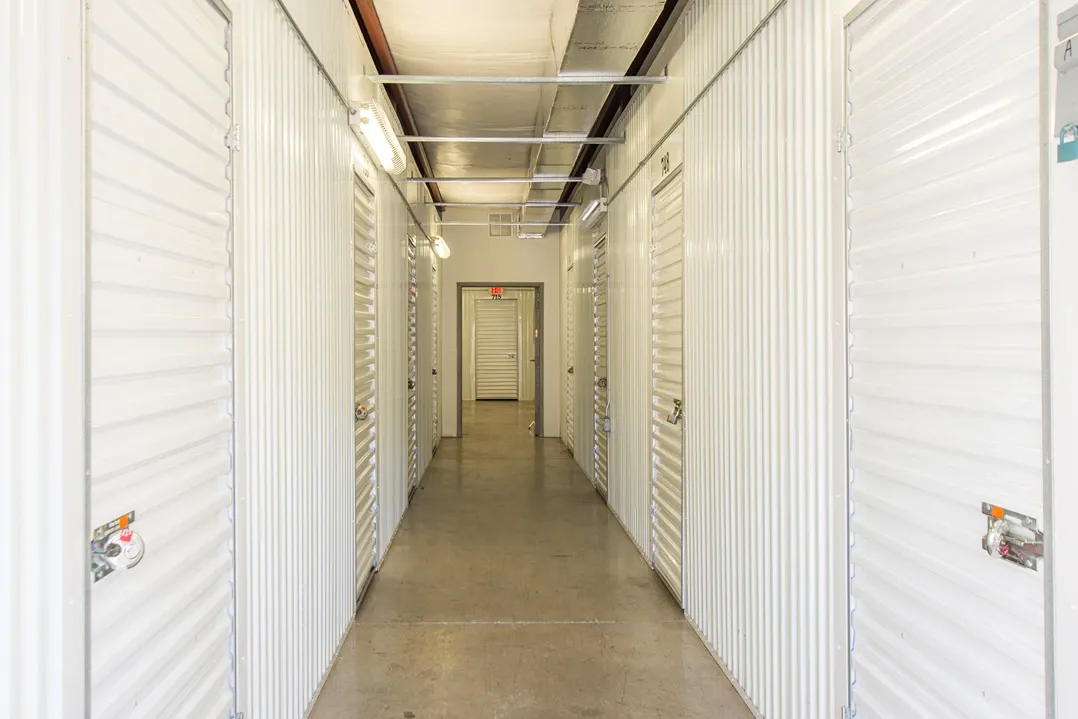 Indoor self storage hallway with secure roll-up units on both sides